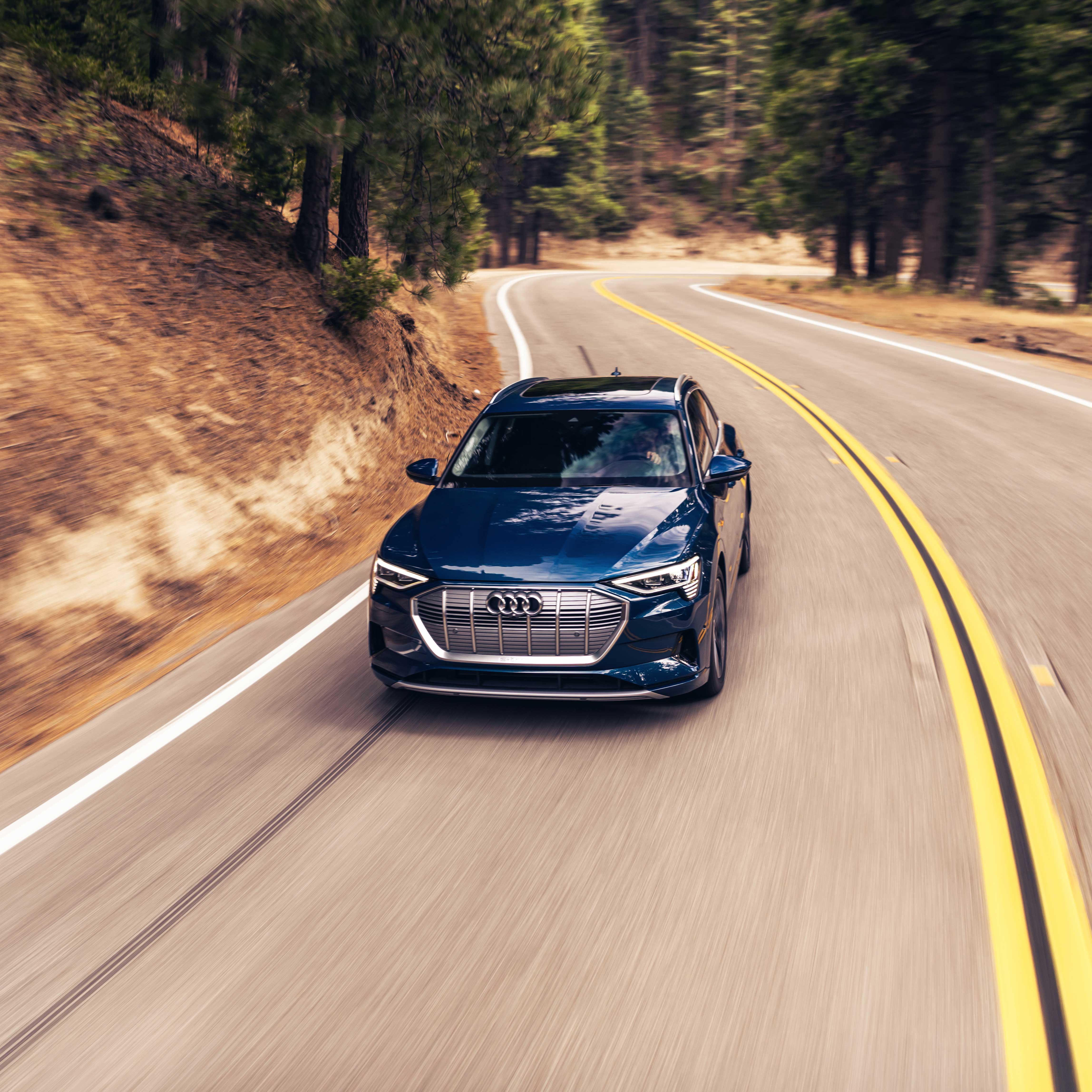 Three-quarter front profile of the Audi e-tron® accelerating.